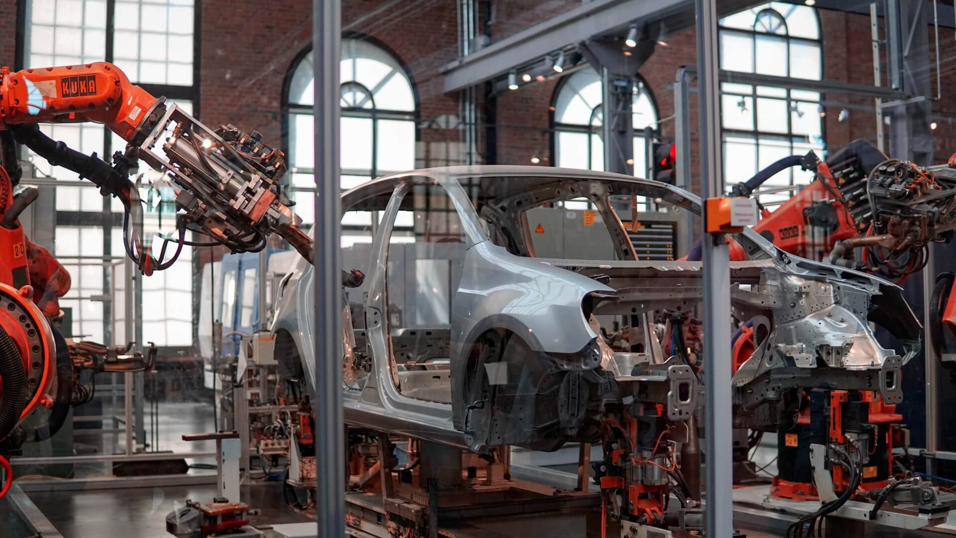Automated robots building a car in factory
